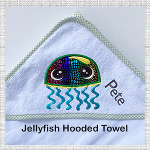 Image of close up green trim hooded bath towel with embroidered Jellyfish